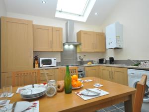 a kitchen with a wooden table with fruit on it at 2 Bed in Blakeney 54766 in Awre