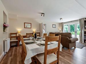 a dining room and living room with a table and chairs at 3 bed property in Sturminster Newton Dorset RCORN in Sturminster Newton