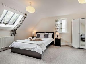 a bedroom with a large bed and two windows at 3 bed property in Sturminster Newton Dorset RCORN in Sturminster Newton