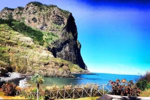 a view of the ocean and a rocky mountain at Pilar Balconies in Funchal City in Funchal