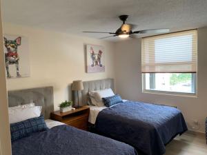 a bedroom with two beds and a ceiling fan at Attractive Penthouse in Isla Verde in San Juan +52 photos