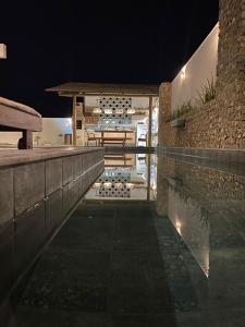a house with a swimming pool at night at Flor de Cacto Beach Home in São Miguel do Gostoso