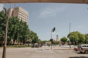 a city street with a lot of cars and motorcycles at ApartHotel Cetate Alba Iulia in Alba Iulia +4 photos