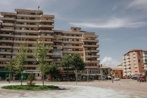 a large apartment building with trees in front of it at ApartHotel Cetate Alba Iulia in Alba Iulia