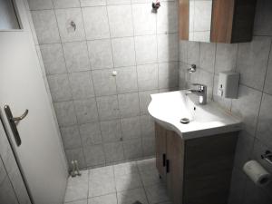 a bathroom with a sink and a shower at Melia Luxury Studio in Thessaloniki