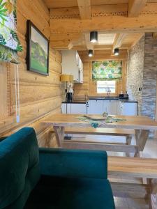 a kitchen and dining room with a table and a couch at Świerkowe Chatki w Koniakowie in Koniaków