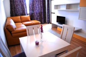 a living room with a table and a couch at Luxury one bedroom apartment 402 in RILA PARK in Borovets