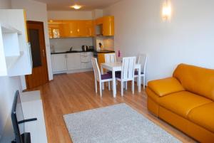 a living room with a couch and a table with chairs at Luxury one bedroom apartment 402 in RILA PARK in Borovets