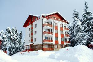 a building with snow in front of it at Luxury one bedroom apartment 402 in RILA PARK in Borovets