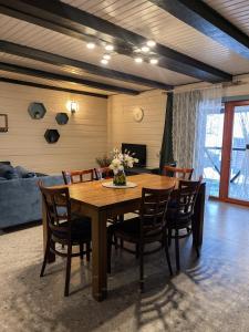 a dining room with a wooden table and chairs at Private House Scherbovets in Zhdenievo