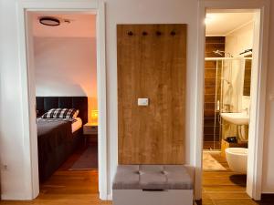 a bathroom with a door leading to a bedroom with a bed at Ski INN apartment Jahorina in Jahorina