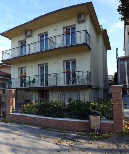 een groot wit huis met een balkon. bij Appartamento ROYAL in Gatteo a Mare