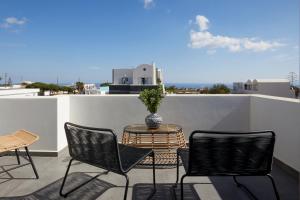 a patio with a table and chairs on a balcony at EPICENTER LUXURY RESIDENCE in Mesaria