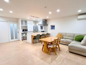 a living room with a couch and a table at Shima Stay holoholo in Zamami