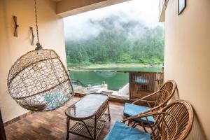 a porch with chairs and a swing at Allure lake front in Nainital