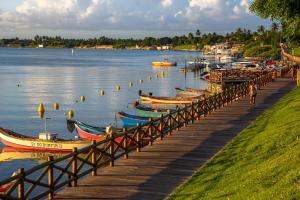 a group of boats parked on a dock in the water at Mar de Aruana - Apartamento Suíte com Ar Aracaju-SE in Aracaju