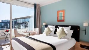 a bedroom with a large bed and a balcony at Residhome Nice Aéroport in Nice