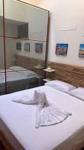 a bedroom with two beds and a towel on the bed at Mantova 4 (trilocale Parma) in Parma