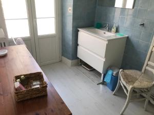 a bathroom with a sink and a table with a drawer at Luchon centre - maison de ville calme et lumineuse in Luchon
