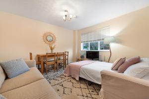 a bedroom with a bed and a couch and a desk at Stylish Short Term Let - Bucks in Bourne End