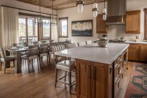 a kitchen and dining room with a table and chairs at Spanish Peaks | Highlands Cabin 30 in Big Sky