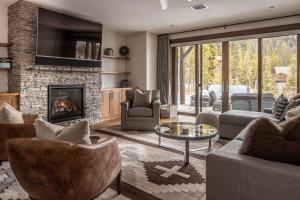 a living room filled with furniture and a fireplace at Spanish Peaks | Highlands Cabin 30 in Big Sky