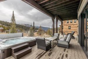 a hot tub on the deck of a house at Spanish Peaks | Highlands Cabin 30 in Big Sky