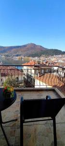 a balcony with a bench and a view of a city at Panos Suite in Kastoria