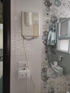 a bathroom with a mirror and a white sink at 2 bedroom, 4 beds, apartment in El sheikh Zayed Cairo Egypt in Sheikh Zayed