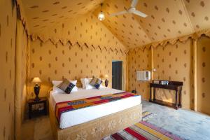 a bedroom with a bed in a tent at Desert Vista Camp in Jaisalmer