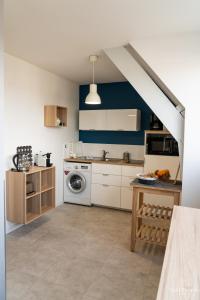 a kitchen with a white stove top oven next to a sink at Les Beaux Jours, Tours in Tours