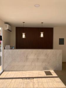 a large marble counter in a room with two lights at La Purisima Hotel in La Paz +37 photos