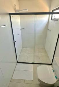 a bathroom with a glass shower and a toilet at Roma Flats in Campo Novo do Parecis