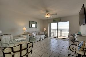 a living room with a couch and a table at Oceanfront Ormond Beach Condo Community Perks! in Ormond Beach