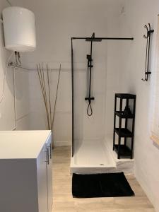a bathroom with a glass shower with a black rug at Casa Alba 2023 in Lillo +23 photos