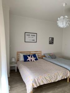 a bedroom with two beds and a chandelier at Casa Alba 2023 in Lillo