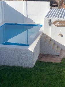 a swimming pool with a staircase next to a house at Casa Alba 2023 in Lillo