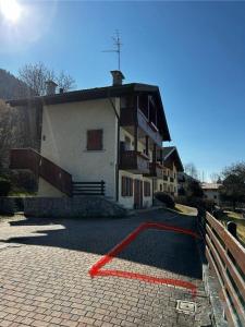 a house with a red line in front of it at Appartamento Costa Verde in Bocenago