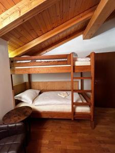 a couple of bunk beds in a room at Appartamento Costa Verde in Bocenago