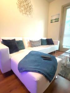a living room with a white couch and a bed at 1Bd Gorgeous Loft in Buckhead Free Wi-Fi, Parking in Atlanta