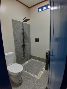 a bathroom with a shower with a toilet in it at anik homestay & dormy Batukaras in Batukaras +41 photos