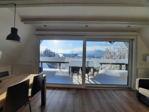 a dining room with a view of the snow covered mountains at Haus mit Bergblick in Siegsdorf