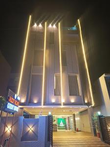 a building with lights on top of it at night at Jazzy Beach Guest House in Visakhapatnam
