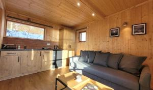 a living room with a couch and a table at Piękny Brzeg in Węgorzewo