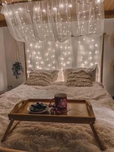 a tray on a bed with a coffee cup on it at Cuib din Fagaras in Avrig