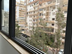 a window with a view of a large building at 30° apartment paradise of the sun in Agadir