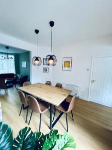a dining room with a wooden table and chairs at Stunning house in Anfield, whole house in Liverpool
