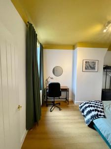 a bedroom with a bed and a desk and a chair at Stunning house in Anfield, whole house in Liverpool