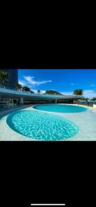 a large pool of water with a bridge in the background at Hotel Nacional Rio de Janeiro in Rio de Janeiro