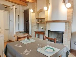 a dining room with a table and a fireplace at Appartamento Sotto i Torricini in Urbino +5 photos